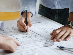 close up of team engineer or architect meeting for project working with partner and engineering tools on model building and blueprint in working site. Construction concept