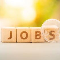 Wood block word JOB and magnifying glass with copy space using as background Choice of the best suited employee, HR, HRM, HRD, job recruiter concepts.